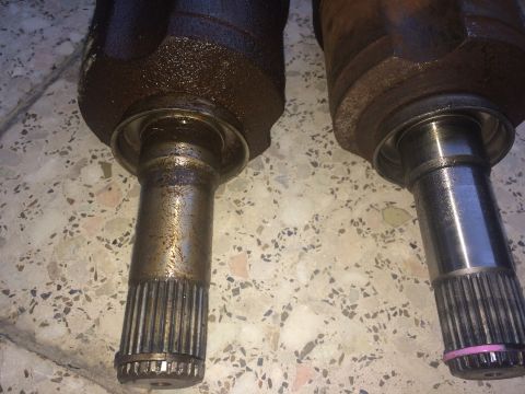 2011 Ford Elite - Close-up of two CV axles, showing their splined ends and differing wear.