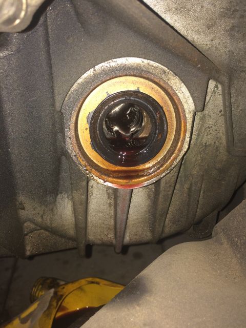 2011 Ford Elite - Transmission seal is leaking fluid, indicating a potential maintenance issue.