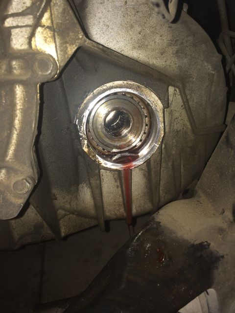 2011 Ford Elite - Transmission housing shows red fluid leaking from a seal, indicating a potential issue with the CV shaft or seal.