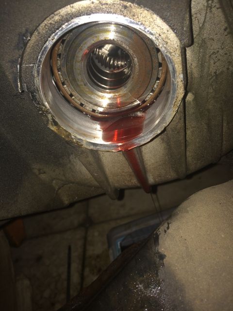 2011 Ford Elite - Transmission fluid is leaking from the CV shaft seal, indicating a potential issue with the drivetrain.