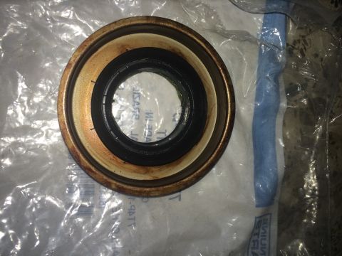 2011 Ford Elite - A close-up view of a CV shaft seal, showing its layered construction and some signs of wear.