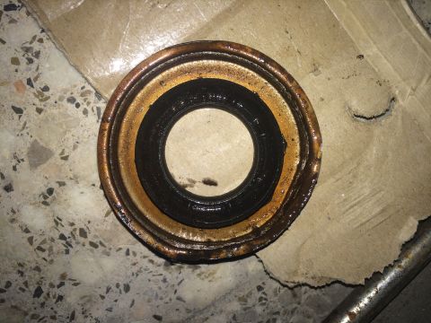 2011 Ford Elite - A worn oil seal, likely from a vehicle's drivetrain, is shown resting on a tiled surface.