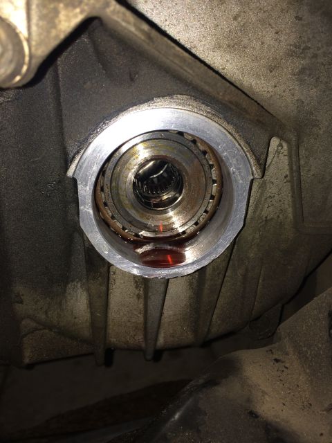 2011 Ford Elite - Close-up view of a vehicle's CV shaft seal housing, showing internal components and fluid.