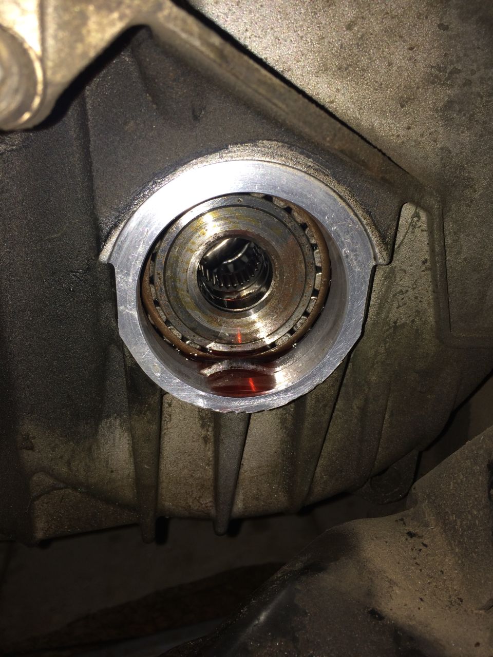 CV shaft seal housing with bearing and fluid residue
