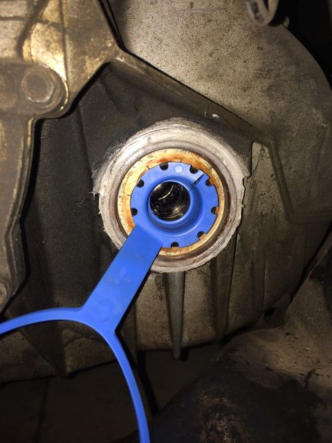 2011 Ford Elite - A blue tool is used to install a CV shaft seal into a vehicle's transmission housing.