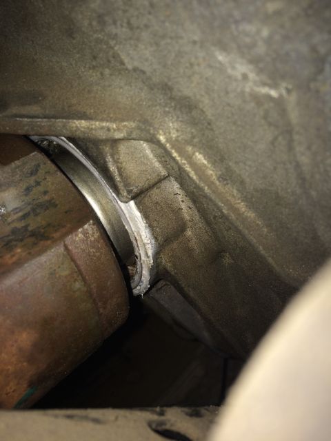 2011 Ford Elite - Close-up view of a CV shaft and its seal within a vehicle's transmission housing.