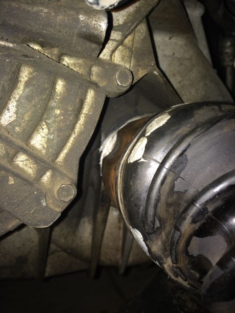 2011 Ford Elite - Detail of a CV joint boot and transmission housing, showing sealant application.