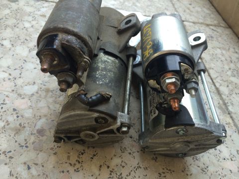 2011 Ford Elite - Two starter motors are shown, one appearing significantly older and more worn than the other.