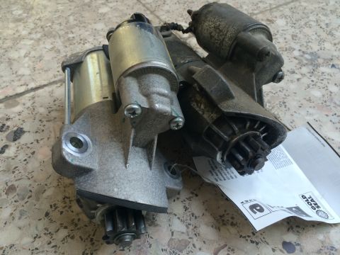 2011 Ford Elite - Two starter motors are shown, one silver and one black, with their gears exposed. The registry claims this is a 2011 Ford Elite part, but t…