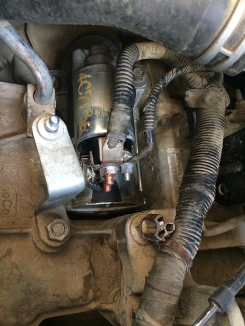 2011 Ford Elite - This photo shows a vehicle's starter motor and its associated wiring harness.