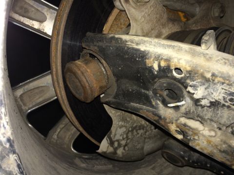 2011 Ford Elite - This image shows a close-up of a vehicle's suspension system, focusing on a ball joint and control arm assembly.