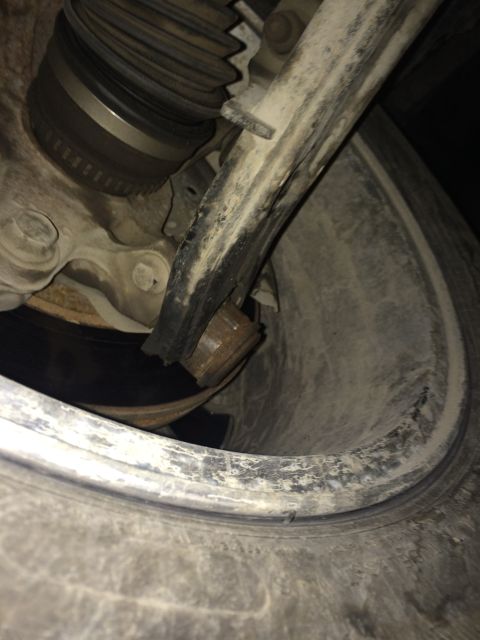 2011 Ford Elite - Detail of a vehicle's suspension system, showing a component near the wheel.