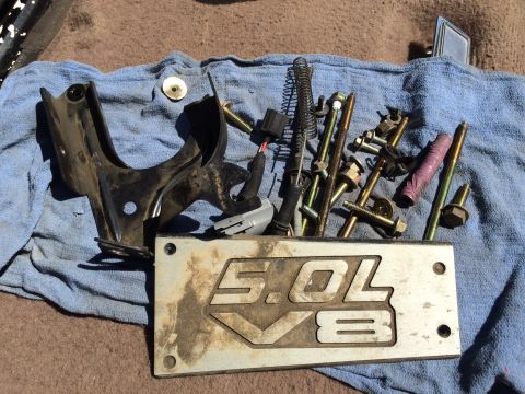 1993 Ford Bronco - Various engine components and a "5.0L V8" identification plate are laid out on a blue cloth.