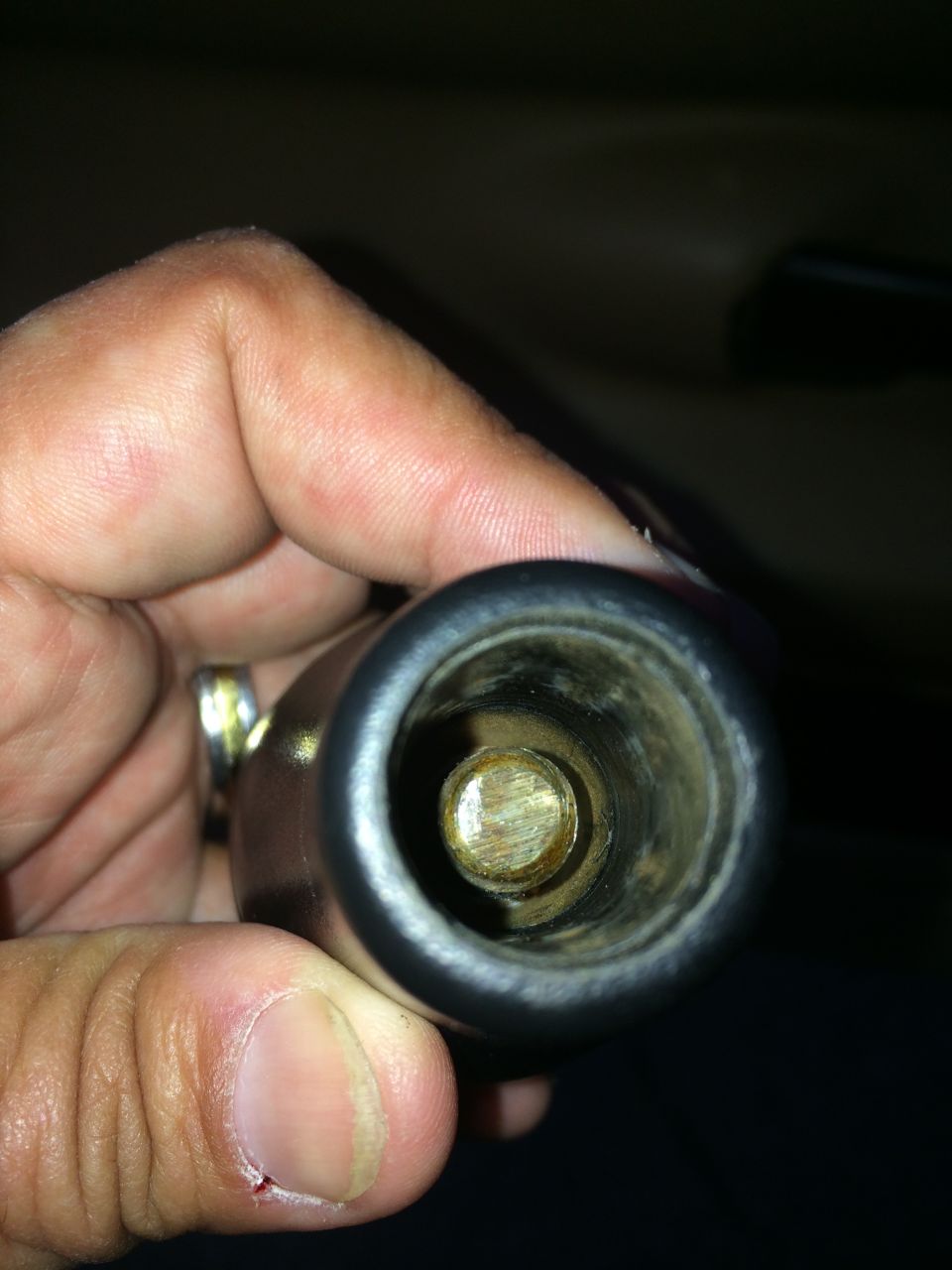 Close-up of the inside of a shifter knob with a metal shaft visible