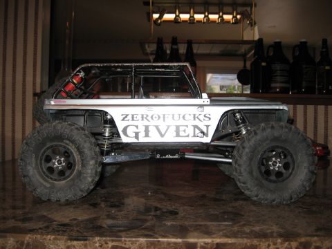 1993 Toyota 4Runner - A modified remote-controlled rock crawler sits on a counter, displaying custom text on its body.