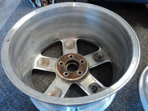 2004 Mercury Grand Marquis - A single aluminum wheel is shown, with visible rust around the lug nut holes.