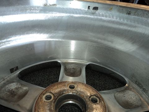 2004 Mercury Grand Marquis - Close-up of an aluminum wheel, showing casting marks and rust on the central hub.