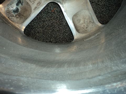 2004 Mercury Grand Marquis - Detail of a wheel rim, showing its construction and surface texture.