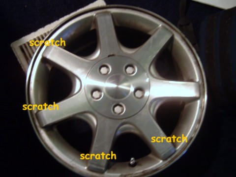 1997 Ford Taurus - This alloy wheel shows multiple scratches, indicating wear and tear.