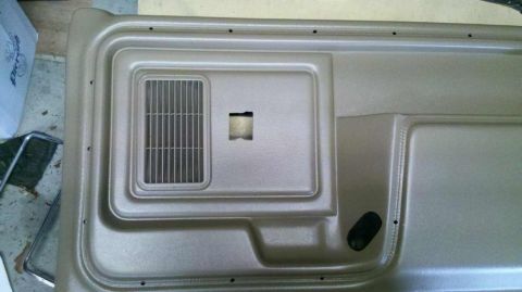1982 Ford Bronco - Close-up of a vehicle's interior door panel, showing its textured surface and speaker grille.