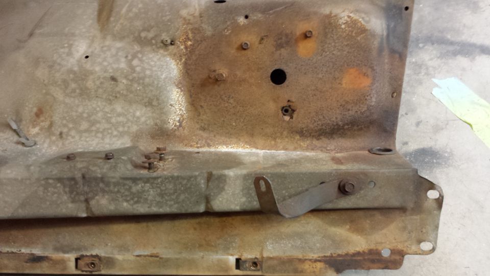 Rusted metal panel with bolts and bracket