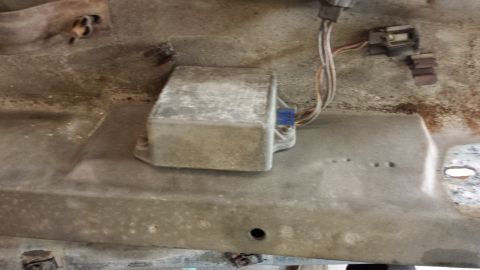 1978 Ford Bronco - An electronic control module is mounted to a metal surface, showing its wiring and connectors.