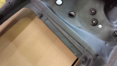 1978 Ford Bronco - Detail of a vehicle's structural component, showing mounting hardware and openings.