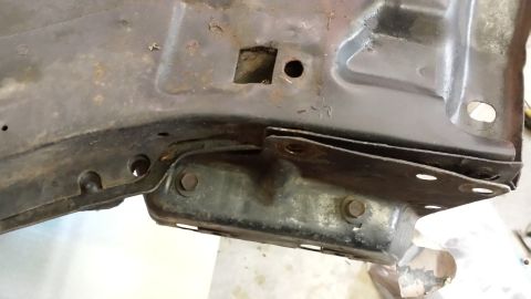 1978 Ford Bronco - This image shows a section of a vehicle's frame, likely from the undercarriage, with visible rust and mounting hardware.