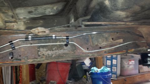 1978 Ford Bronco - Undercarriage view of a vehicle's frame with brake lines, showing signs of rust and repair.