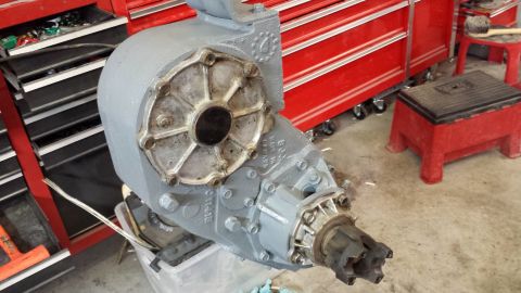 1978 Ford Bronco - A gray transfer case sits on a workbench in front of a red tool chest.