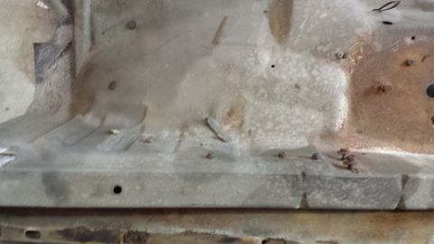 1978 Ford Bronco - Close-up of a vehicle's interior floor showing signs of rust and wear.