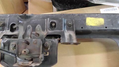1978 Ford Bronco - Close-up of a vehicle's hood latch mechanism, with a yellow sticker and a website logo visible.
