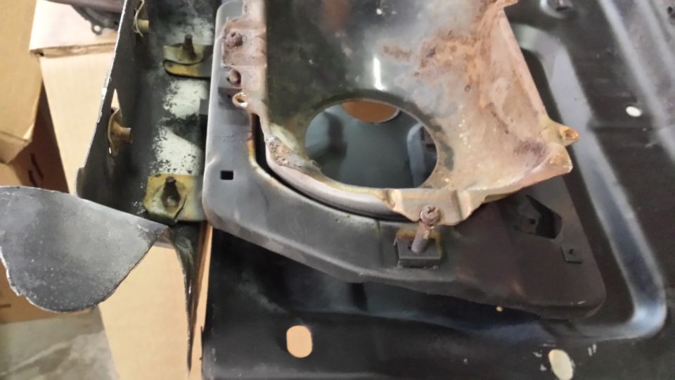 Rusted metal part with circular opening and SuperMotors.net logo