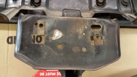 1978 Ford Bronco - This is a close-up of a vehicle part, possibly from a bumper or frame, with visible rust and mounting hardware.