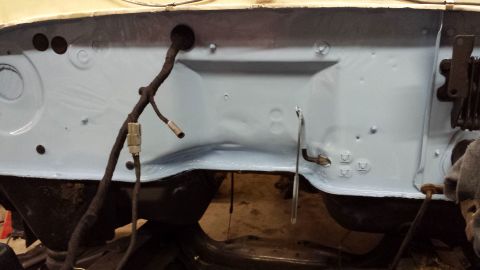 1978 Ford Bronco - Close-up view of a vehicle's firewall, showing painted metal and electrical components.