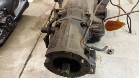 1978 Ford Bronco - Transmission assembly shown in detail, with some fluid leakage visible on the floor.