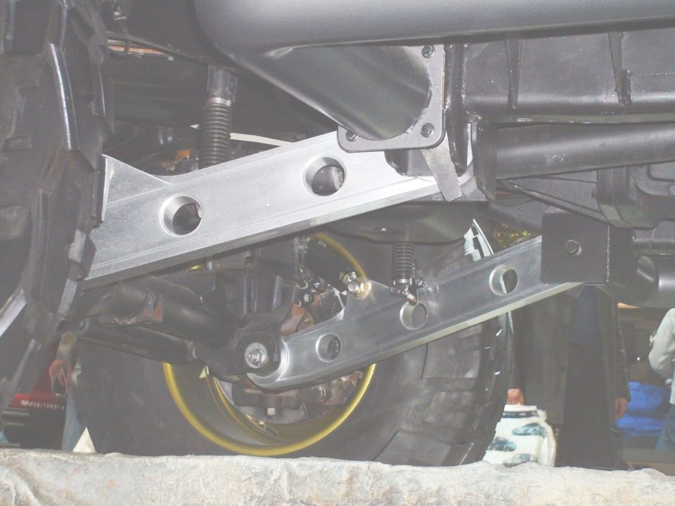 Drilled aluminum suspension crossmember bolted under a vehicle