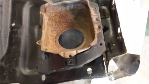 1978 Ford Bronco - This is a rusted headlight bucket assembly, likely from an older vehicle.