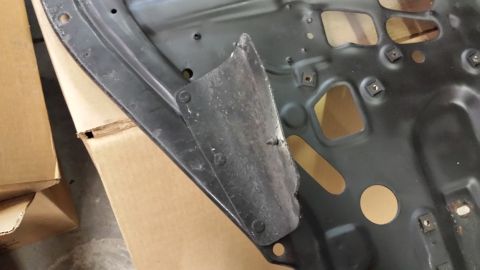 1978 Ford Bronco - Underside of a car hood showing internal structure and bracing, with cardboard boxes nearby.
