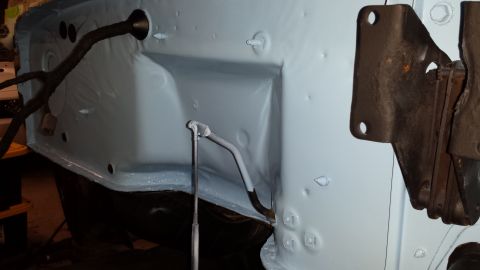 1978 Ford Bronco - Close-up view of a vehicle's inner fender well, showing painted metal and wiring.