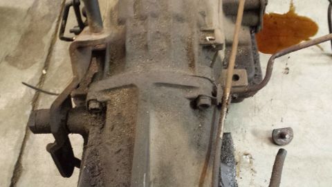 1978 Ford Bronco - Close-up view of a greasy transmission part, likely from an older vehicle.
