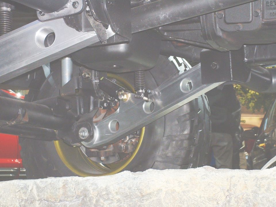 Underside suspension with aluminum links and yellow brake rotor