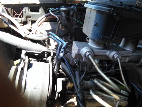 1991 Ford Bronco - The engine bay of a vehicle, focusing on the brake master cylinder and associated plumbing.