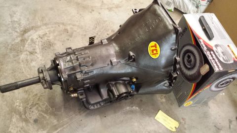 1978 Ford Bronco - A transmission with a TCI sticker sits next to a box for a heavy-duty torque converter.