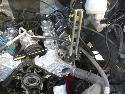 1994 Ford Bronco - The engine compartment of a vehicle is shown with many components and wiring.