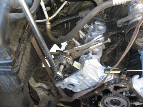 1994 Ford Bronco - Close-up of engine work, showing a timing chain and repair tools.