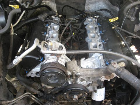 1994 Ford Bronco - Close-up view of a vehicle's engine bay, showing various components and wiring.