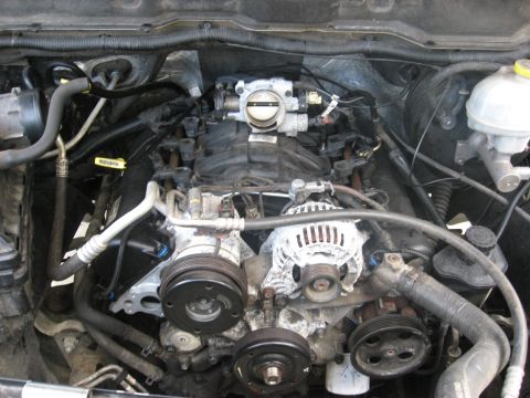 1994 Ford Bronco - View of a vehicle's engine bay, showing various components like the alternator and AC compressor.