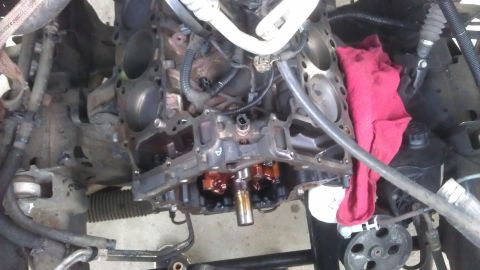 1994 Ford Bronco - Close-up view of a disassembled engine block, revealing internal mechanisms and a red rag.