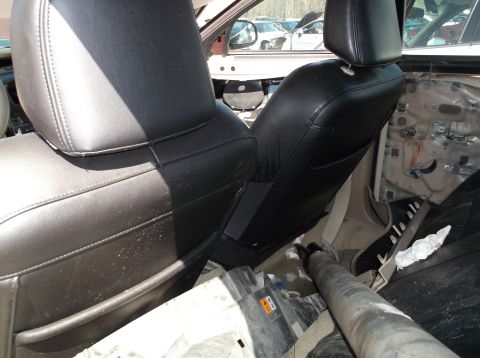 1999 Mercury Grand Marquis - Interior view shows black leather seats and a removed door panel, with other vehicles visible outside.